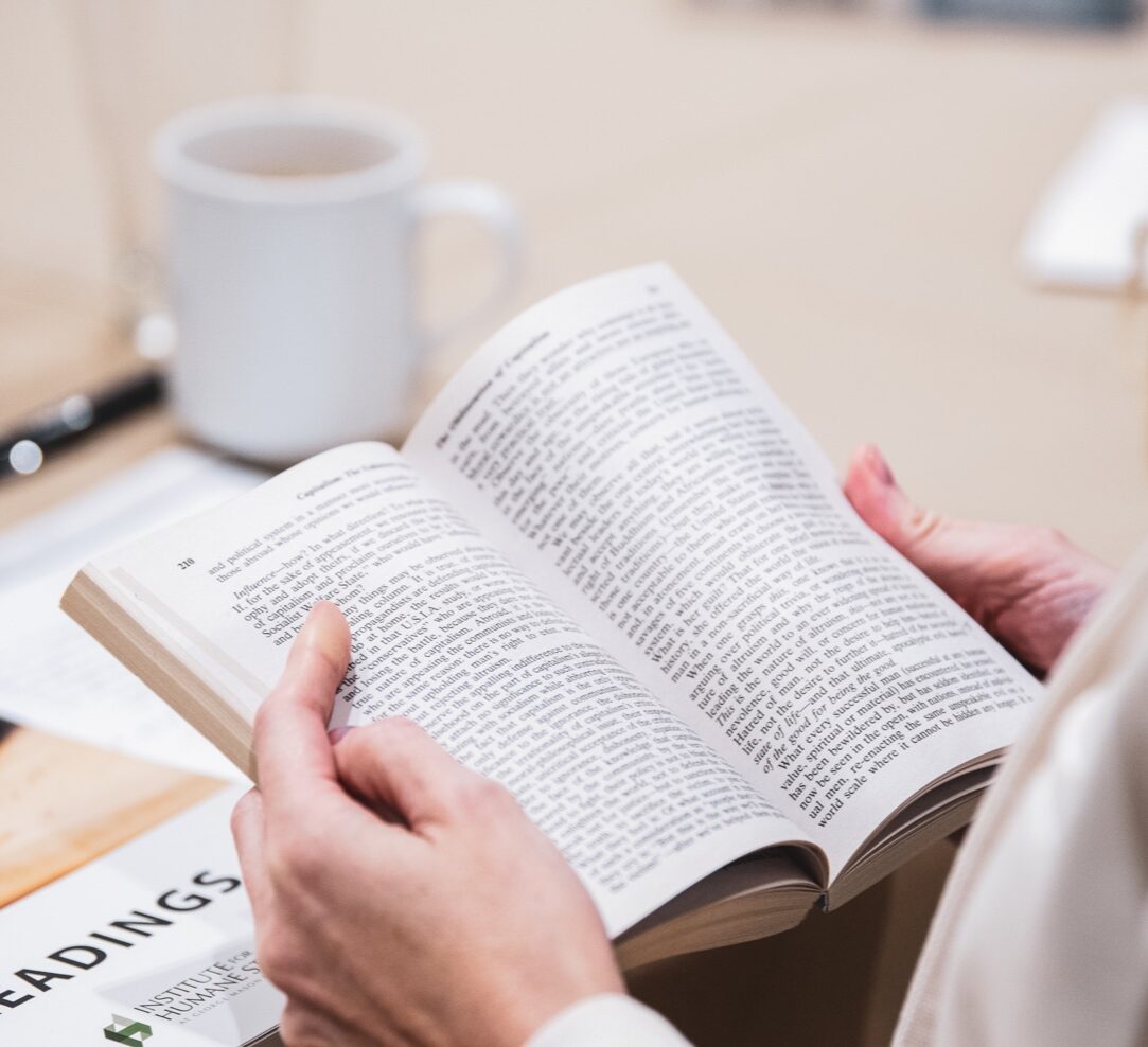 Institute for Humane Studies (IHS)-Hands holding open a book at an IHS event